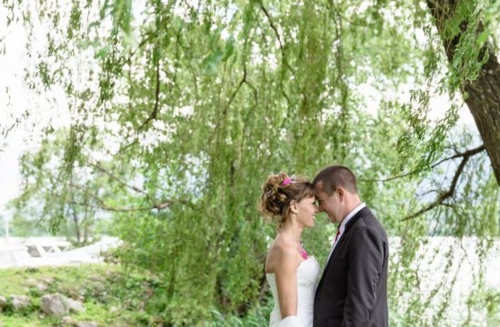 Les mariés de profil sous un sole pleureur au bord du lac du Bourget